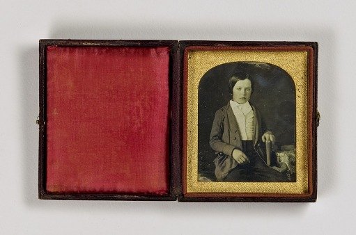 Untitled (Young Boy with Book at Table)