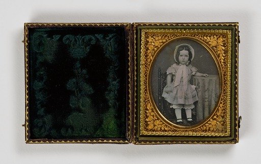 Untitled (Young Girl in a Hat, Standing on Chair by Table)