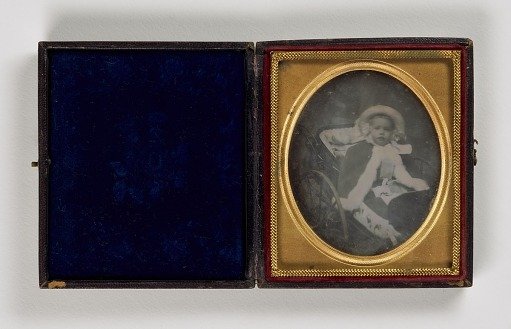 Untitled (Young Girl in Fur-Trimmed Coat in Wagon)